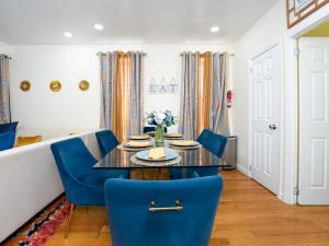 a dining room with a table and blue chairs at A Slice of Paradise vacation rental in Brooklyn