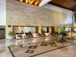 a lobby with chairs and tables in a building at The Patra Bali Resort & Villas - CHSE Certified in Kuta