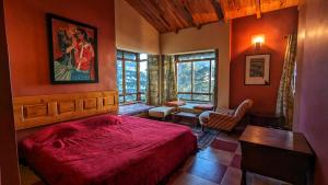 a bedroom with a red bed in a room at Mountain View 3bhk Near Mall Road Deodar Retreat in Dalhousie