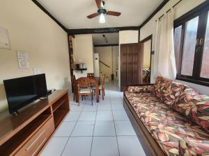 a living room with a couch and a flat screen tv at Residencial Kahunas II in São Sebastião