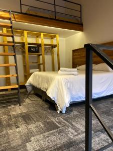 a bedroom with two bunk beds and a ladder at EcoLofts Croacia 1028 in Punta Arenas