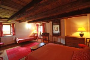a living room with a bed and a couch at Le masbareau, gite le vieux domaine in Royères-Saint-Léonard