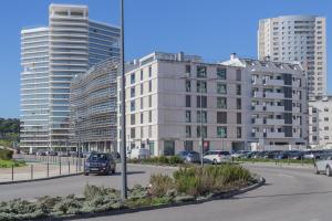 a street with cars parked in front of tall buildings at LDapartments - Spacious Lisbon Haven w/Lift&Garage in Lisbon