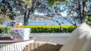 a table with a cup of coffee and a view of the water at 'Reverie' by HolidayCo in Hardys Bay