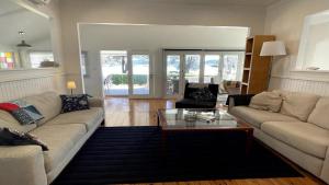 a living room with a couch and a coffee table at 'Reverie' by HolidayCo in Hardys Bay +13 photos