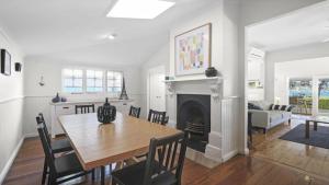 a dining room with a table and a fireplace at 'Reverie' by HolidayCo in Hardys Bay