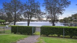 a fence with a view of a body of water at 'Reverie' by HolidayCo in Hardys Bay