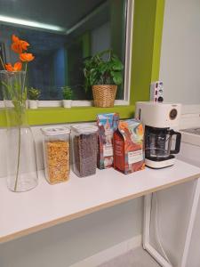 a counter with food and a coffee maker on it at Four Seasons House (Female only) in Seoul