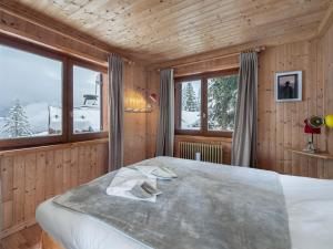 a bedroom with a large bed in a room with windows at Chalet Courchevel 1850, 4 pièces, 4 personnes - FR-1-564-97 in Courchevel