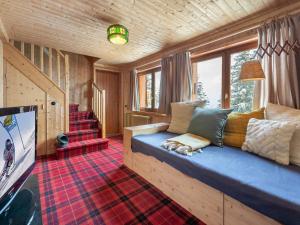 a living room with a blue couch in front of a window at Chalet Courchevel 1850, 4 pièces, 4 personnes - FR-1-564-97 in Courchevel