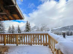 a snow covered deck with a view of the mountains at Chalet Courchevel 1850, 4 pièces, 4 personnes - FR-1-564-97 in Courchevel