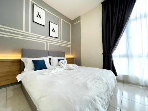 a bedroom with a large white bed with a window at MesaHill Homestay, Nilai by S&T Homez in Nilai