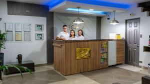 a group of people standing at a bar at Hotel El Sol Inn in Aguachica