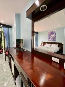 a large mirror in a bedroom with a bed at Riviera Patong in Patong Beach