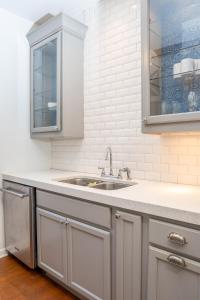 a kitchen with gray cabinets and a sink at Spacious 2 Bed Apt in Atlanta near Piedmont Park in Atlanta +22 photos