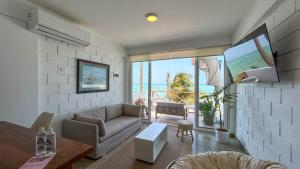 a living room with a couch and a view of the ocean at Marina by Wynwood House in Máncora