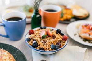 a table with a bowl of breakfast food and a cup of coffee at Renaissance Waterford Oklahoma City Hotel in Oklahoma City