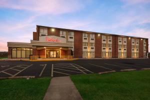 a hotel with a parking lot in front of it at Red Roof Inn Martinsburg in Martinsburg