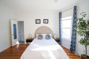a bedroom with a white bed with blue accents at Spacious 2 Bed Apt in Atlanta near Piedmont Park in Atlanta