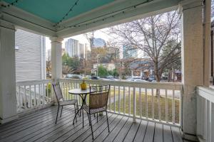 a porch with two chairs and a table on it at Spacious 2 Bed Apt in Atlanta near Piedmont Park in Atlanta