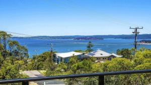 a house on a hill with a view of the water at 'Gone Coastal' by HolidayCo in Killcare