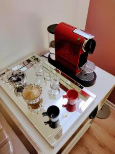 a coffee maker on a counter with cups and glasses at The Best Urban Deluxe - Duplex Studio - Hotel QLTY Faria Lima - by LuXXoR in Sao Paulo