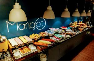 a buffet line with many different types of food at The Best Urban Deluxe - Duplex Studio - Hotel QLTY Faria Lima - by LuXXoR in Sao Paulo