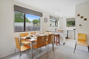 a kitchen and dining room with a table and chairs at Rose Cottage - Lake Coleridge Holiday Home in Lake Coleridge