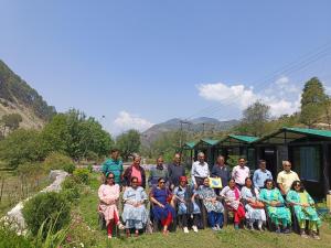 a large group of people posing for a picture at Jayara Resort And Cafe in Barkot