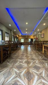 an empty church with wooden pews and blue lights at River Park International Resort in Chitwan
