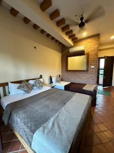 a bedroom with two beds in a room at River Park International Resort in Chitwan +53 photos
