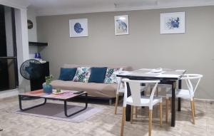 a living room with a table and a couch at Apartamento con piscina cerca al mar Amoblado Rodadero Sur in Gaira