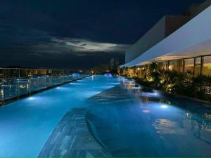 a swimming pool at night on a building at The Song WinHome Apartment in Vung Tau