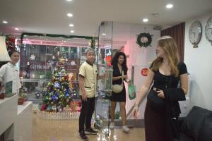 a group of people standing around a christmas tree at Hanoi Aria Central Hotel & Spa in Hanoi