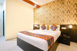 a bedroom with a large bed in a room at FabHotel Sai Vihar in Kolshet