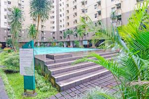 una piscina en medio de un edificio en OYO 93456 Apartemen Gateway Cicadas By Inpro Ii en Bandung