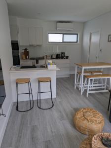 a kitchen with two stools and a table and a counter at 2 bedroom apartment with Garden views in Sydney in Sydney