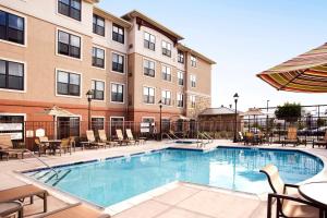 a pool at a hotel with chairs and tables at Residence Inn San Diego Oceanside in Oceanside