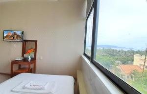 Postel nebo postele na pokoji v ubytování Senkotel Nha Trang Managed by NEST Group