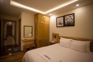 Postel nebo postele na pokoji v ubytování Senkotel Nha Trang Managed by NEST Group