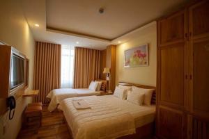Postel nebo postele na pokoji v ubytování Senkotel Nha Trang Managed by NEST Group