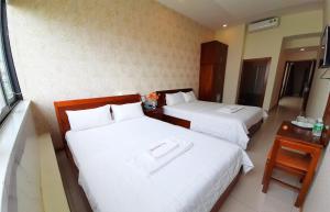 Postel nebo postele na pokoji v ubytování Senkotel Nha Trang Managed by NEST Group