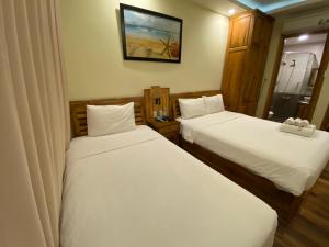 Postel nebo postele na pokoji v ubytování Senkotel Nha Trang Managed by NEST Group