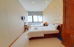Postel nebo postele na pokoji v ubytování Senkotel Nha Trang Managed by NEST Group