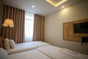 Postel nebo postele na pokoji v ubytování Senkotel Nha Trang Managed by NEST Group