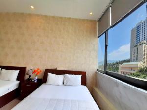 Postel nebo postele na pokoji v ubytování Senkotel Nha Trang Managed by NEST Group