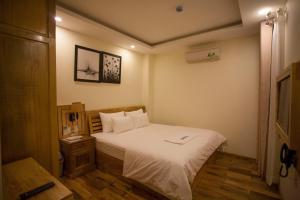 Postel nebo postele na pokoji v ubytování Senkotel Nha Trang Managed by NEST Group