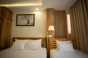 Postel nebo postele na pokoji v ubytování Senkotel Nha Trang Managed by NEST Group