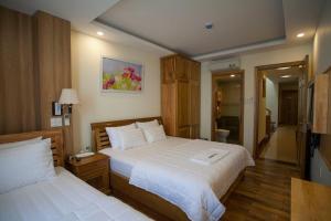 Postel nebo postele na pokoji v ubytování Senkotel Nha Trang Managed by NEST Group