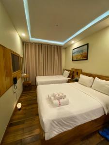 Postel nebo postele na pokoji v ubytování Senkotel Nha Trang Managed by NEST Group